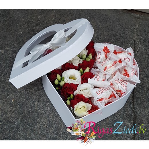 Flowers and candies in a heart-shaped box
