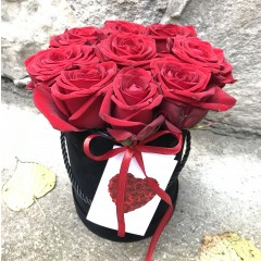 Красные розы в черной круглой коробке