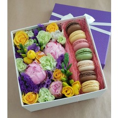 Box with fresh flowers and macaroons